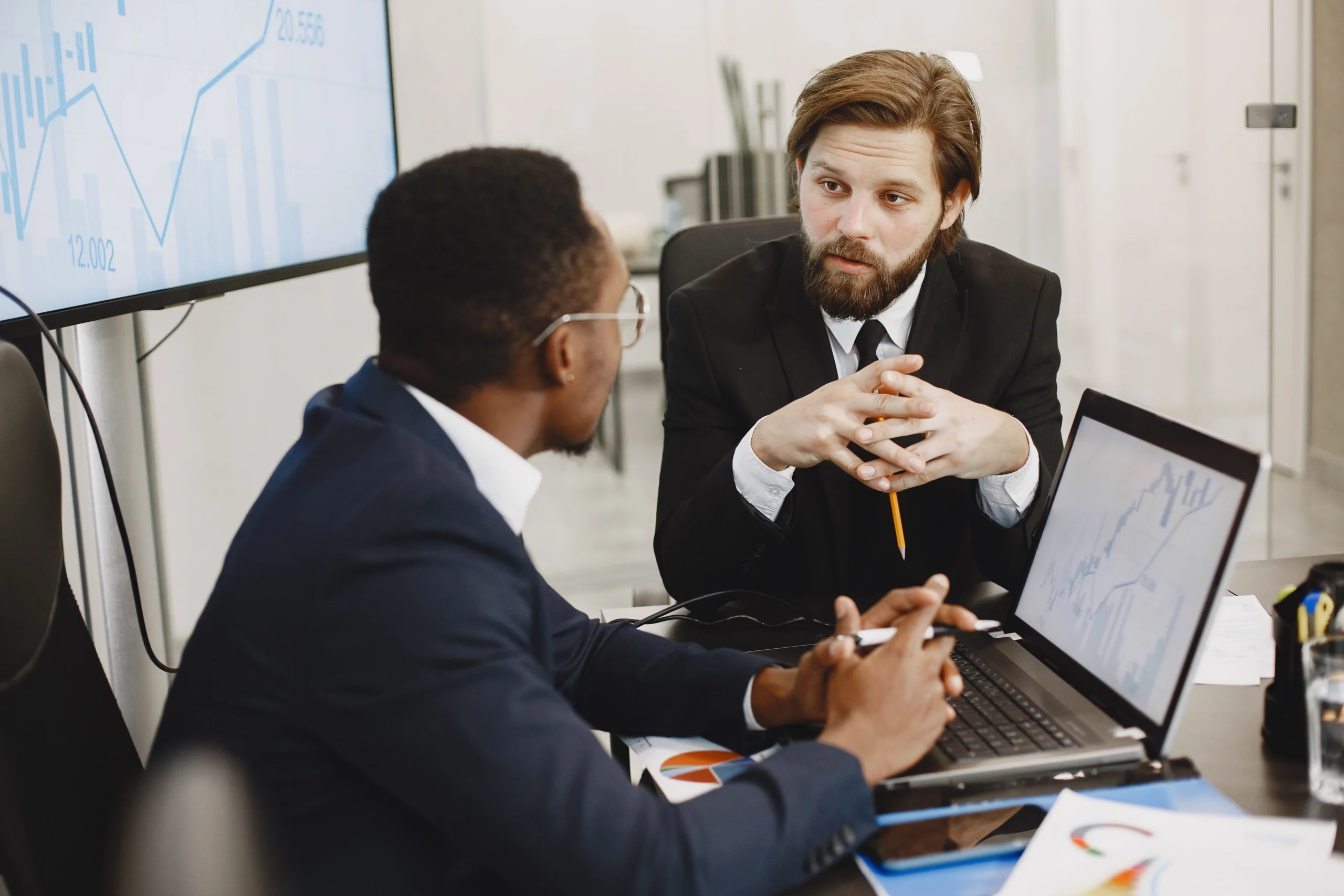 Benefits of Hiring a Fractional CFO with a business owner meeting a fractional CFO to discuss financial strategy and growth