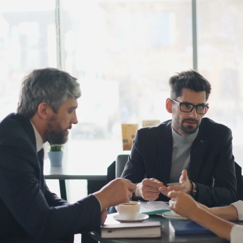 Benefits of a Fractional CFO helping a business owner review financial reports and growth strategies
