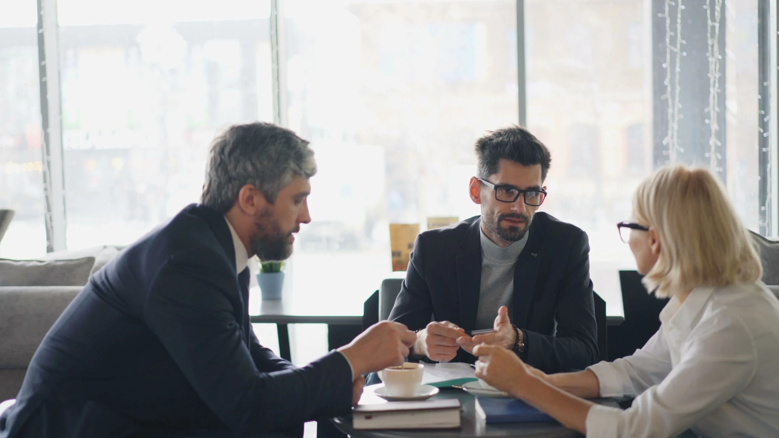 Benefits of a Fractional CFO helping a business owner review financial reports and growth strategies