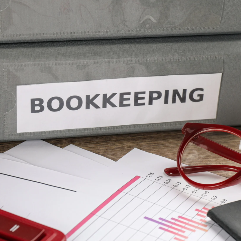 Contract for Bookkeeping Services being reviewed by a small business owner and a professional bookkeeper.