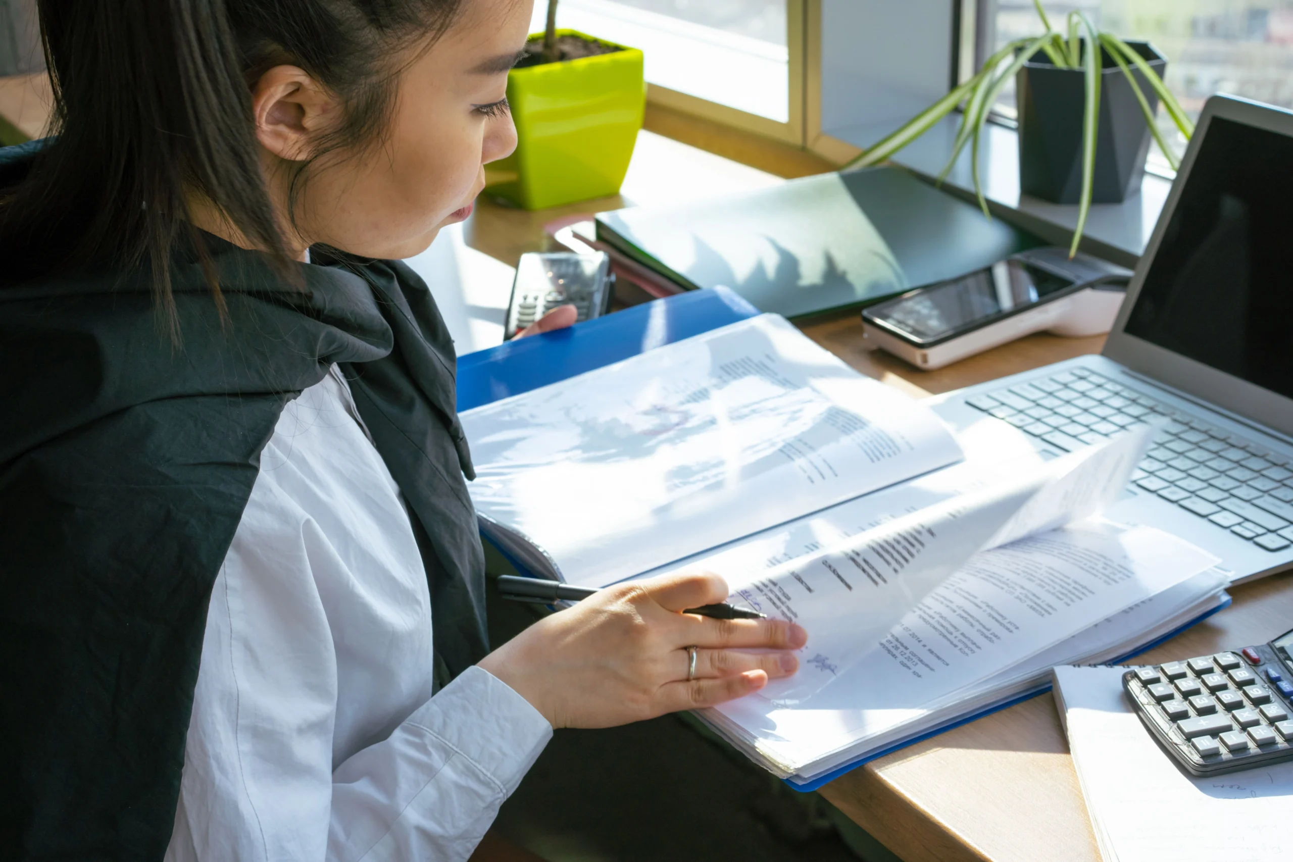 How Much Is Bookkeeping Services with a professional bookkeeper reviewing financial records for a small business owner
